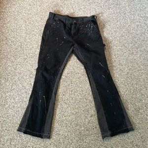 Flared Black icon distressed carpenter jeans, splatter paint design.